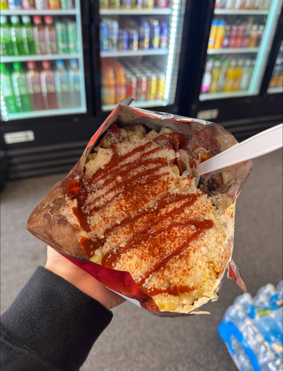 Dorilocos: an open bag of Doritos loaded with esquites, cheese and hot sauce