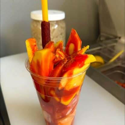 Mango cup with chamoy and a tamarind straw
